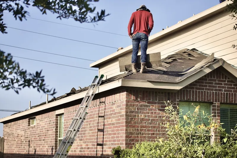 Professional roofer working on a residential roof in Bay Village